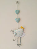White and blue hanging metal chicken