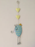 Blue and yellow metal hanging chicken
